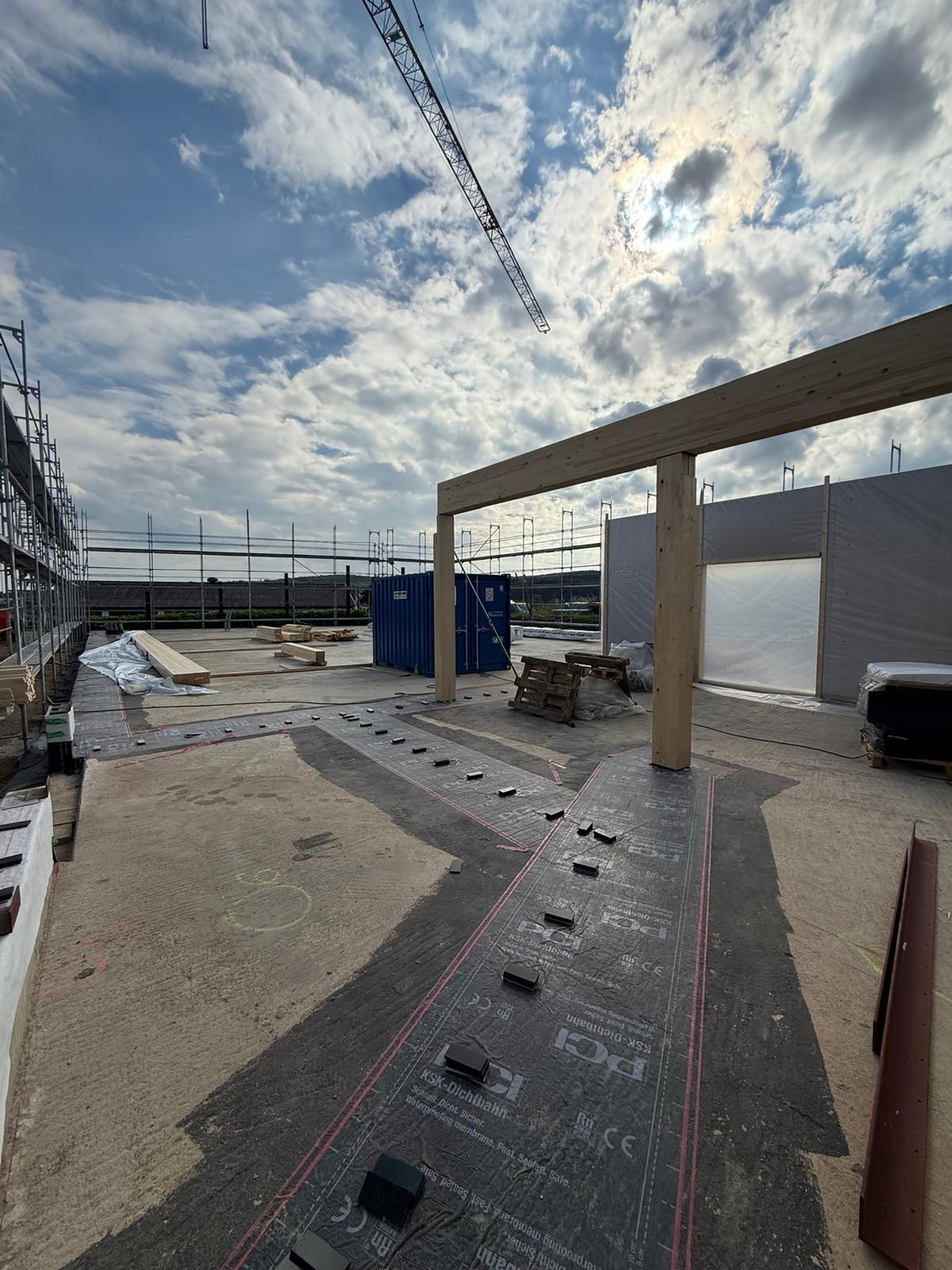 Scaffolding and walls are being erected on the foundation