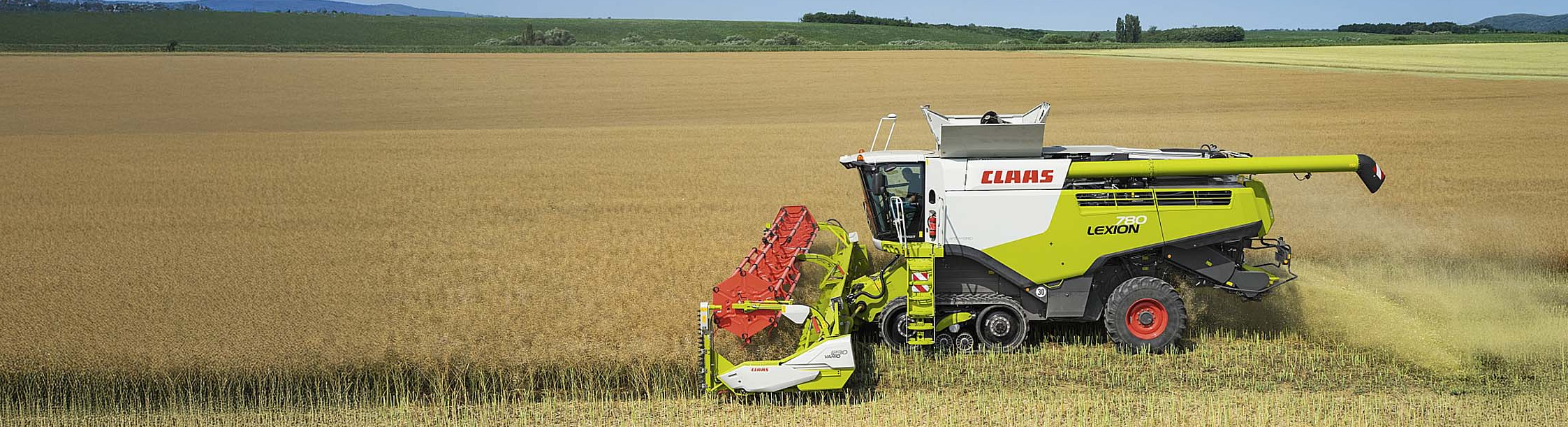 A CLAAS combine harvester at work in a field.